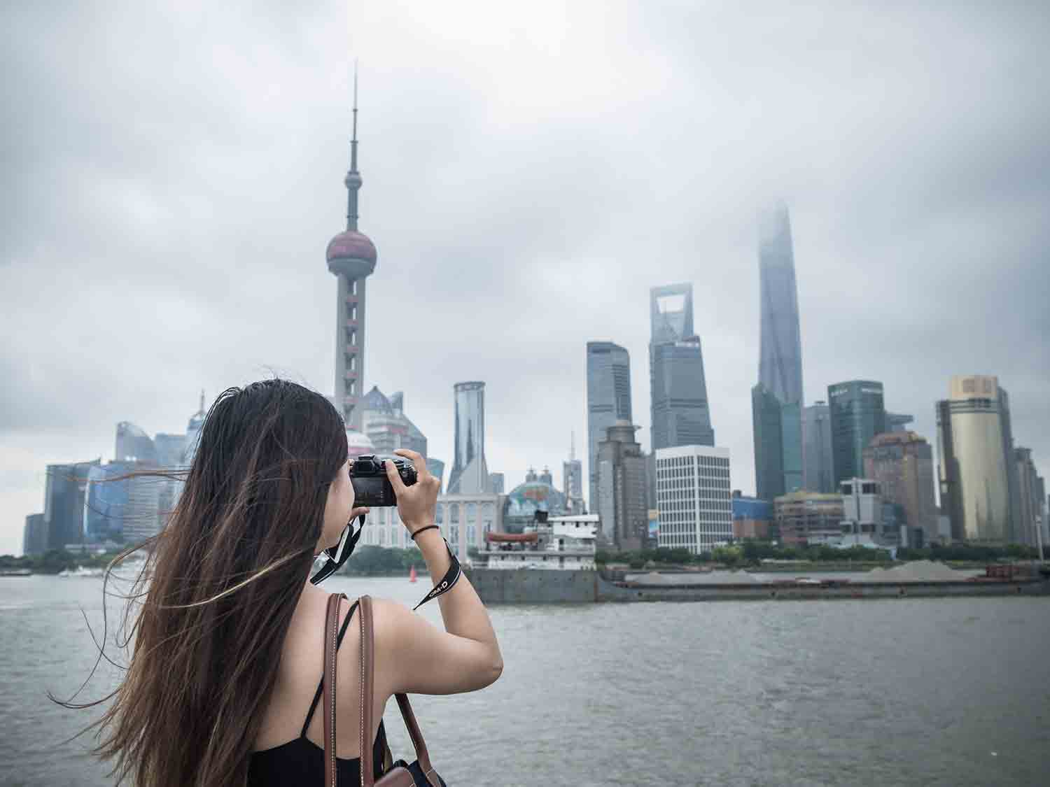 Anna taking a photo of the Shanghai skyline