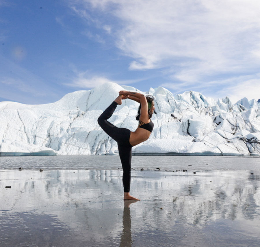 Woman doing yoga in the snow