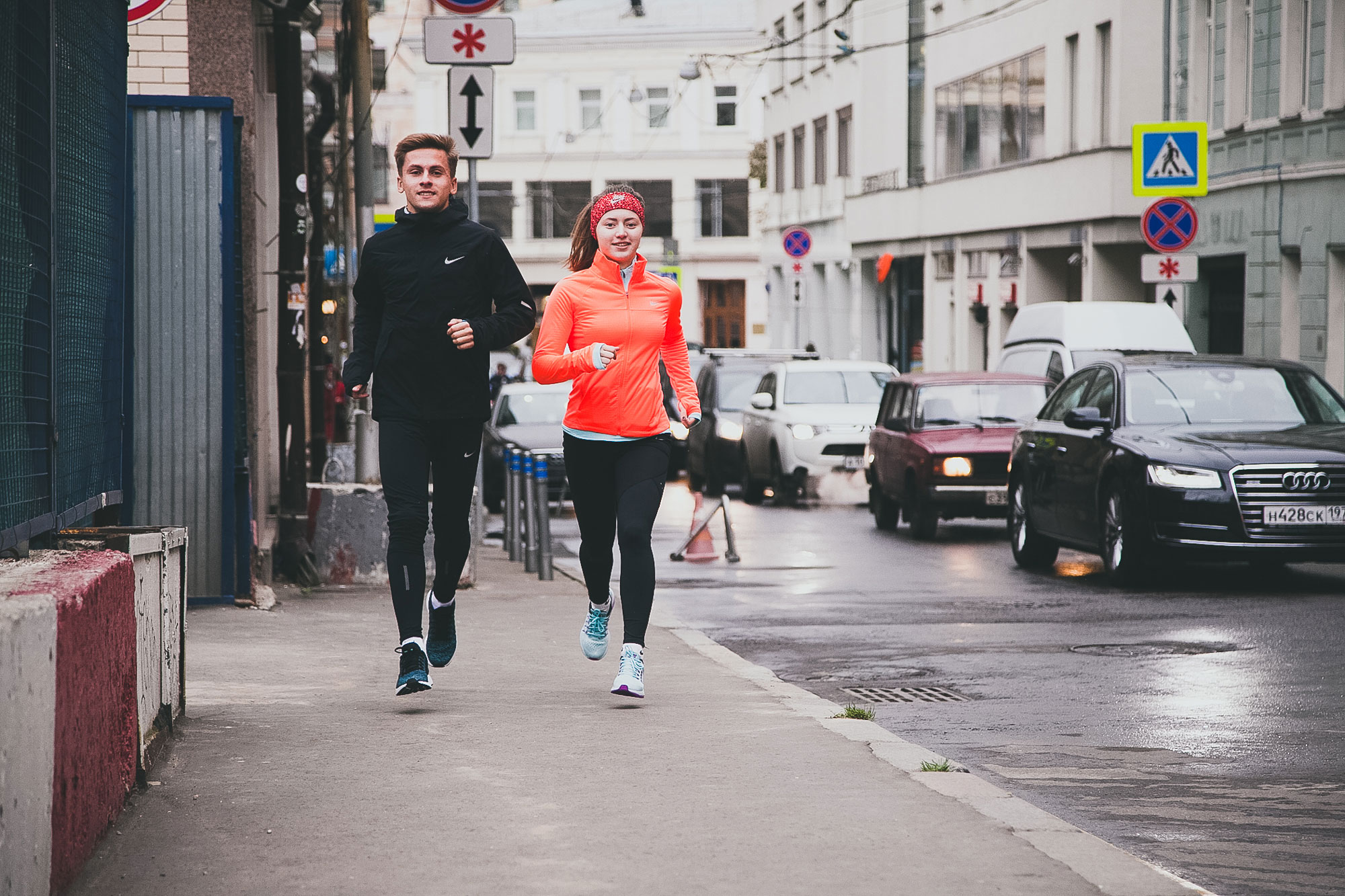 Boy and girl running together in a city scene