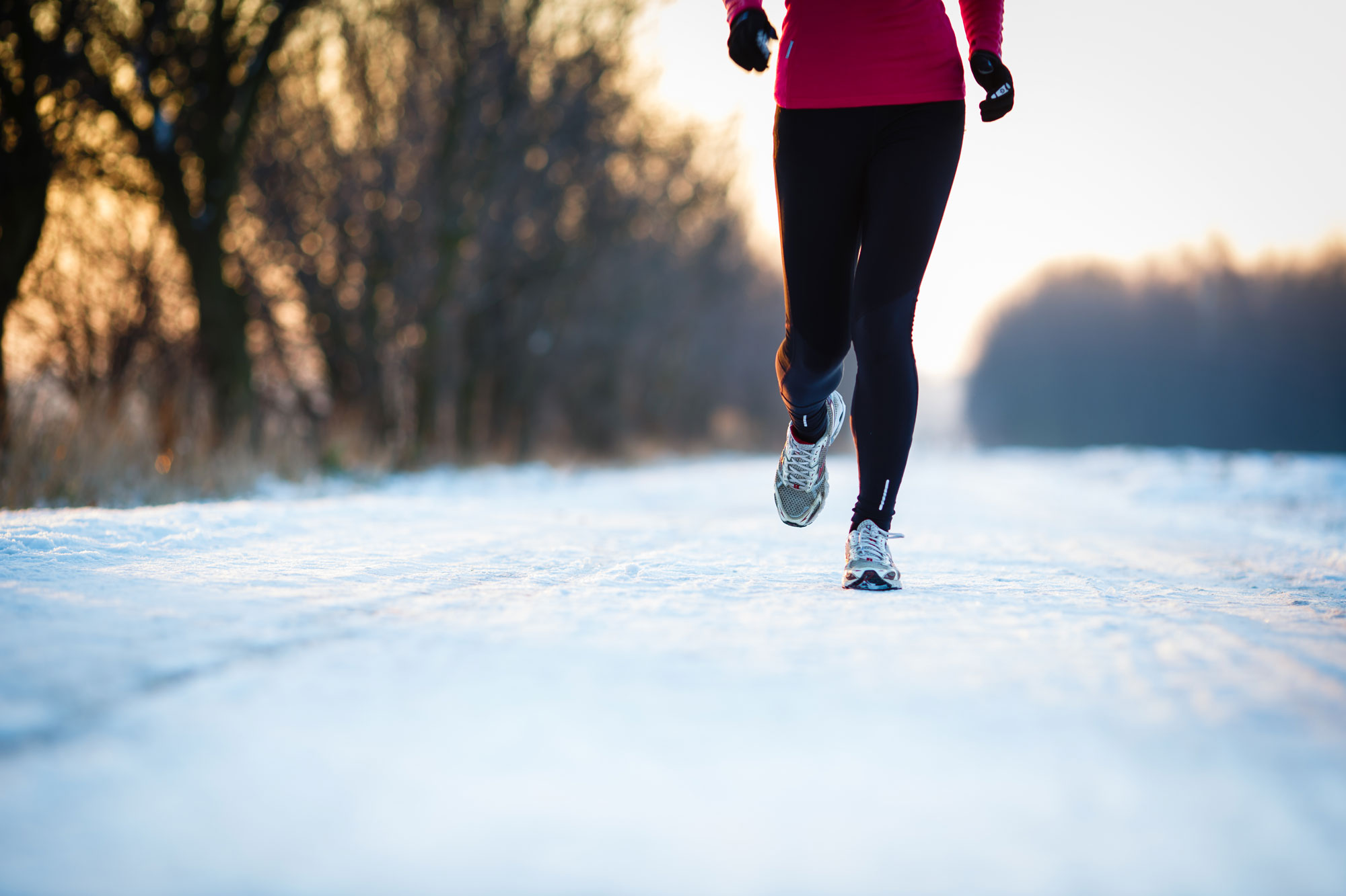 A runner jogging through snow