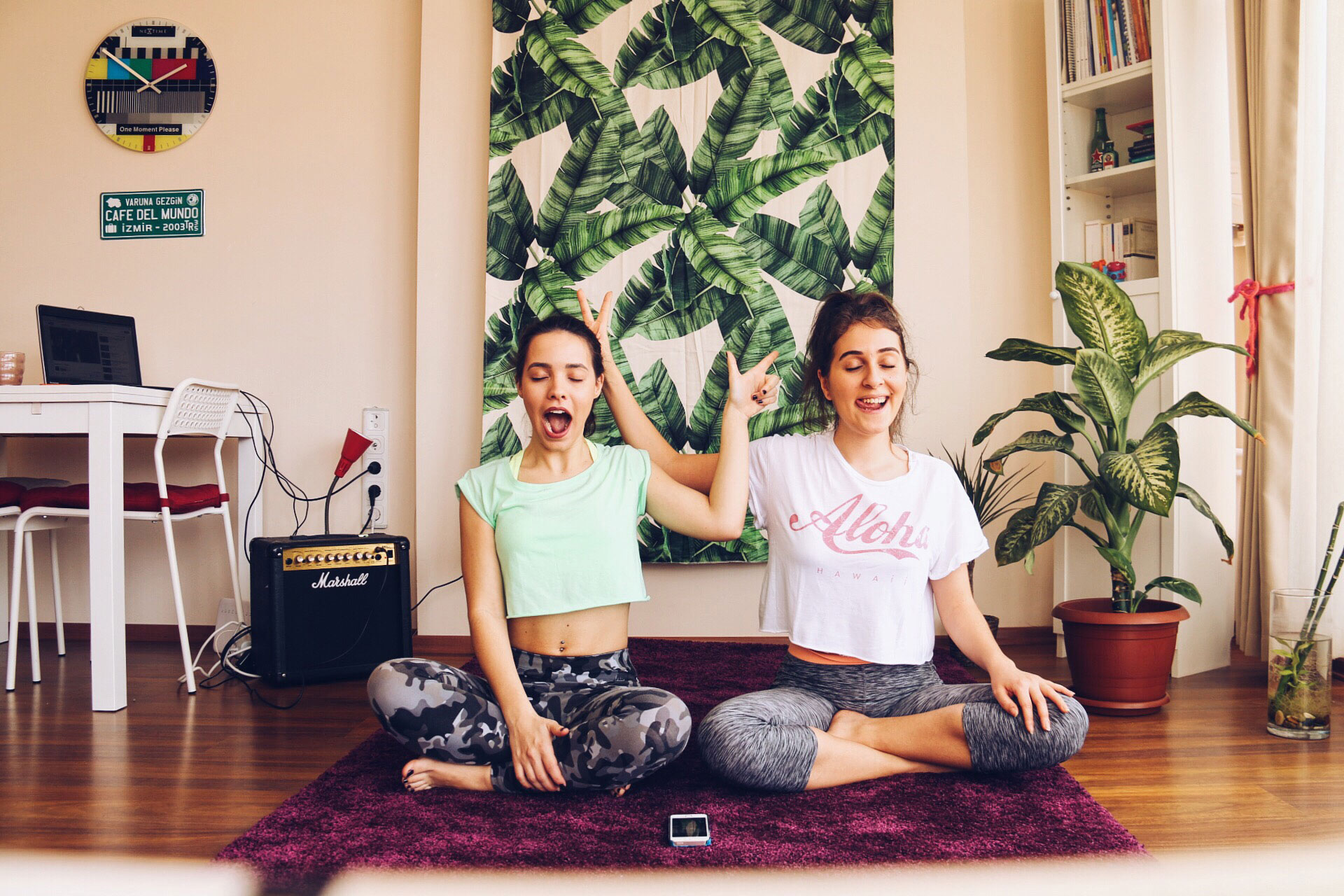 Two roommates practicing yoga together