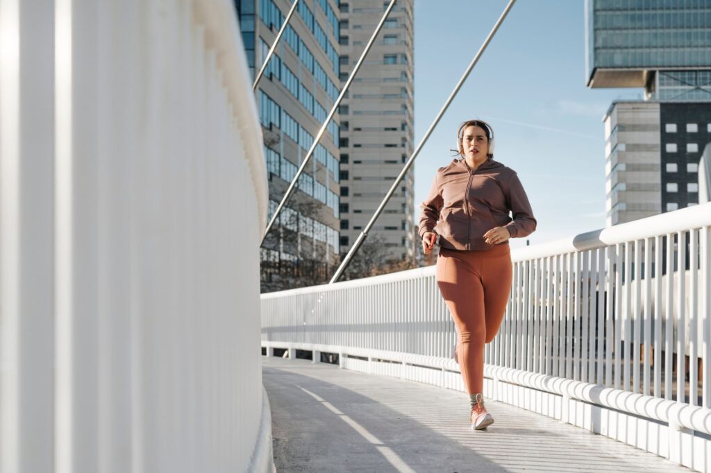 Woman running in the cold across a bridge