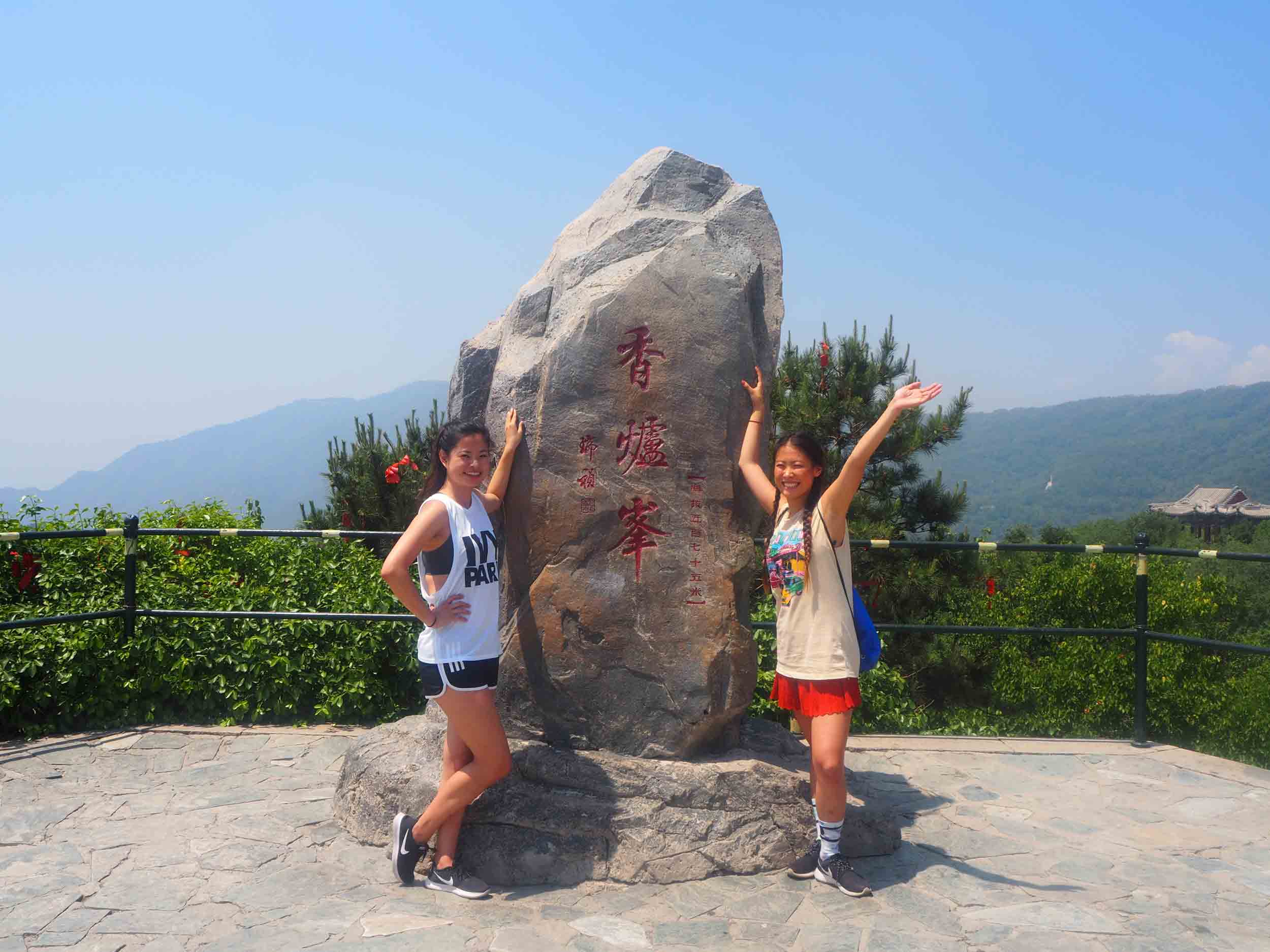 Anna and friend posing at the top of a hike