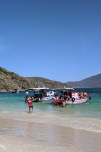 A boat in the water with tourists around the boat