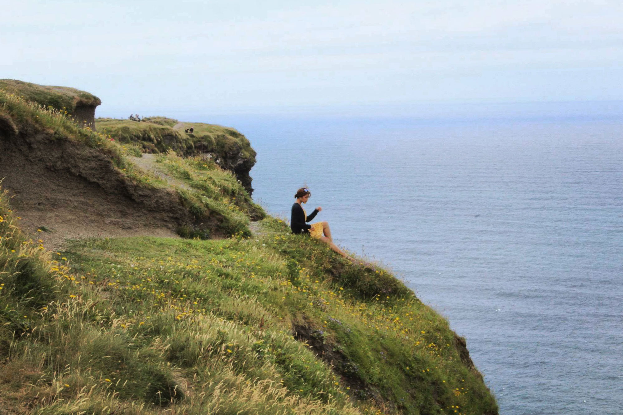 Friend gazing at the sea at the Cliffs of Moher