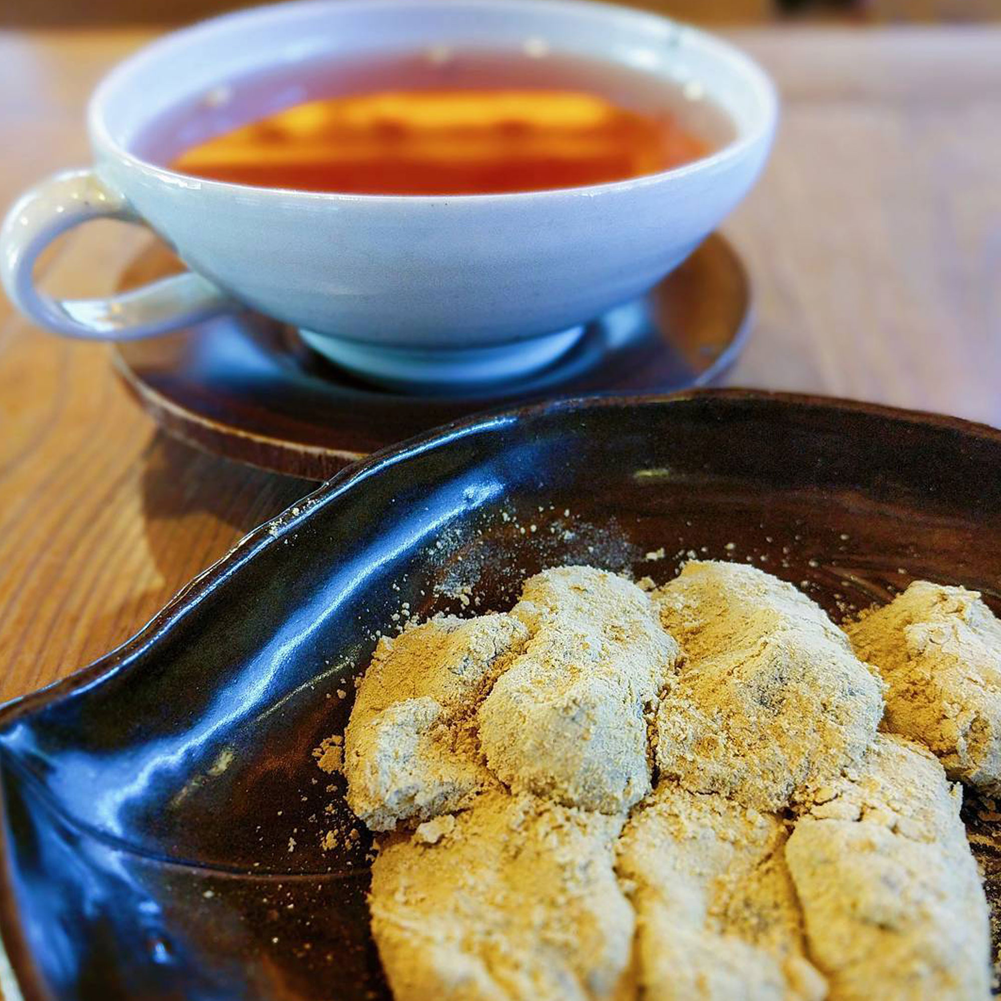 Powdered rice cakes and tea in the background.