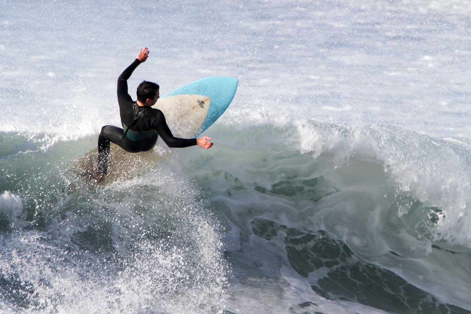 male student catching a wave