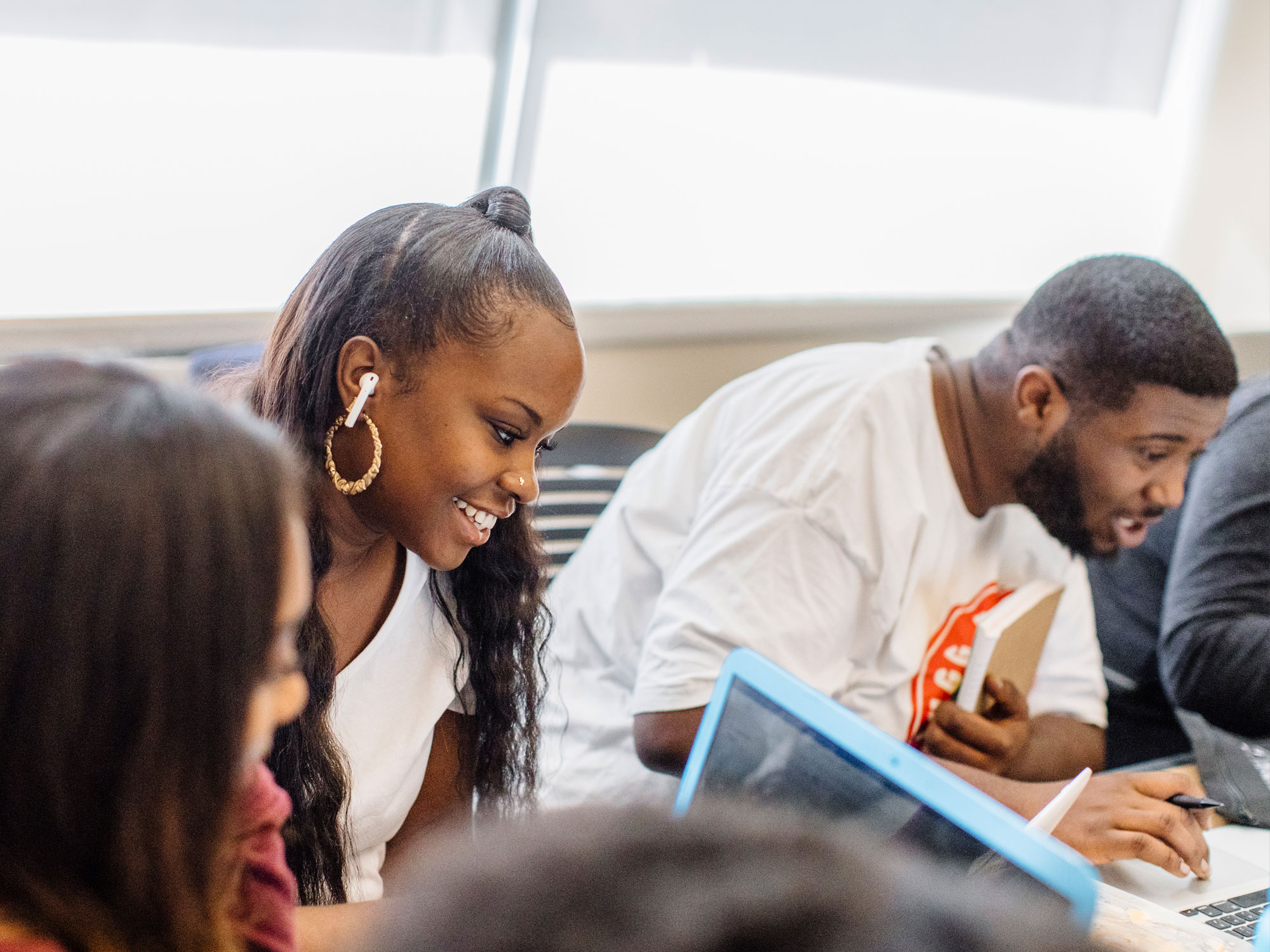 Two students looking at a computer. 