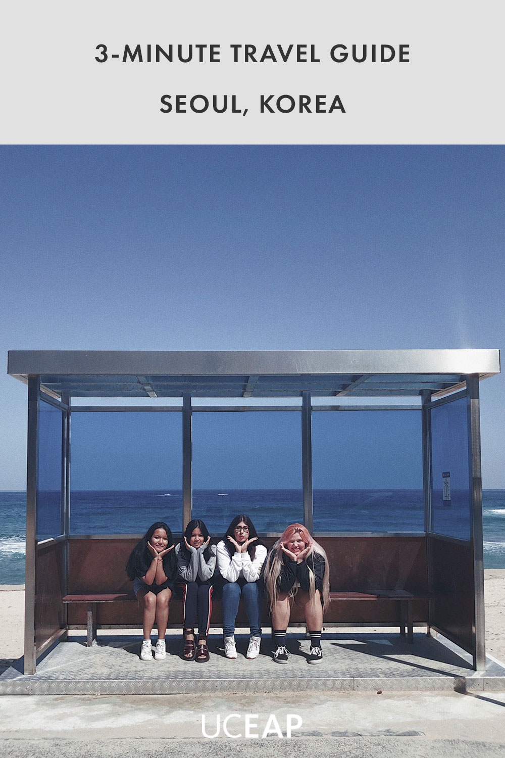 Three students sitting at a bus stop at Jumunjin Beach