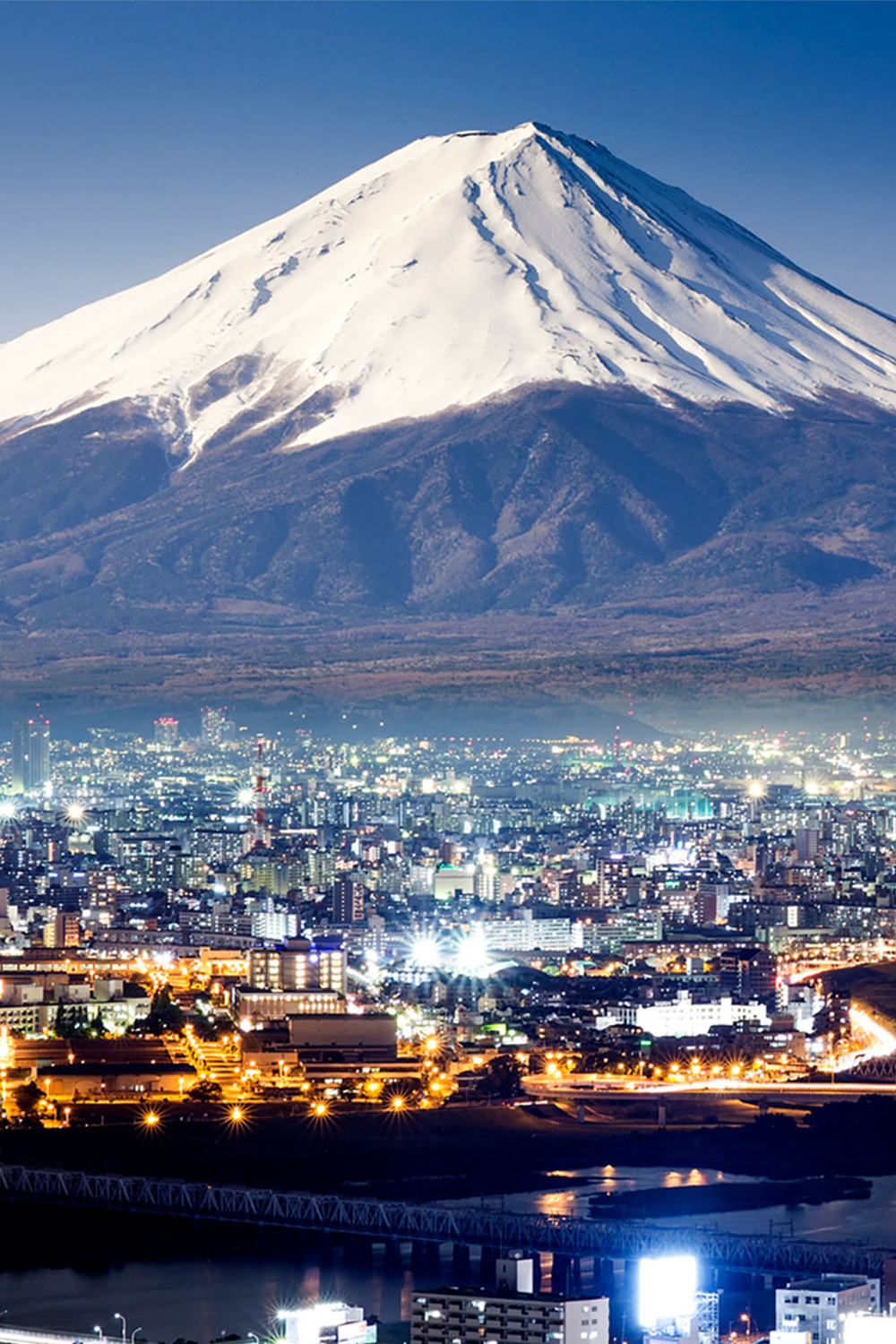 View of Mt. Fuji and Tokyo skyline at dusk.