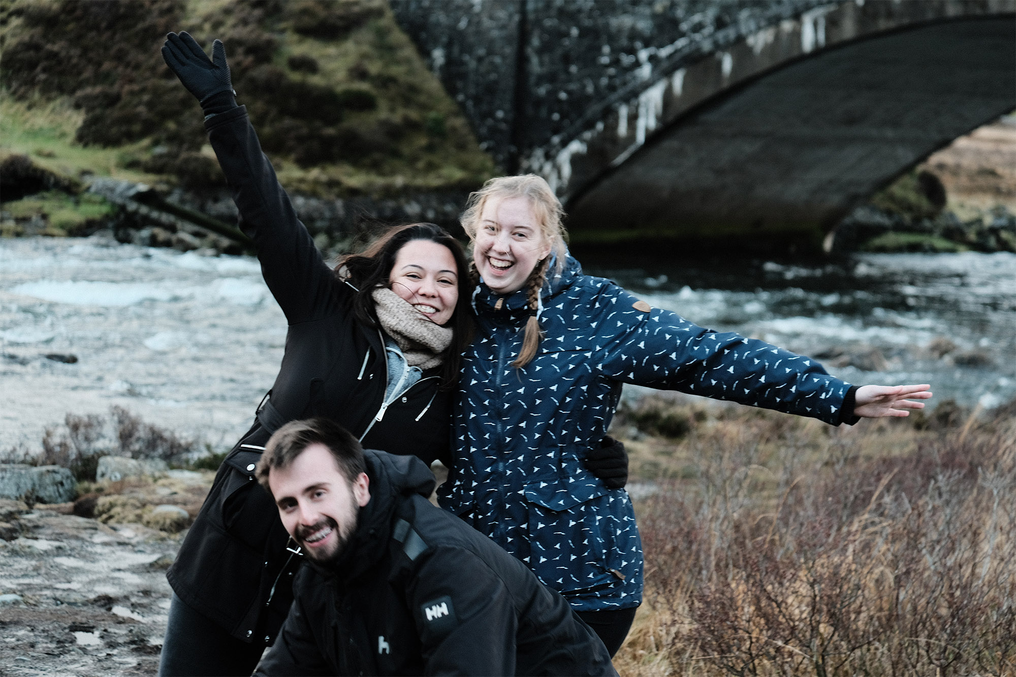 3 students smiling in Fort William, Scotland.