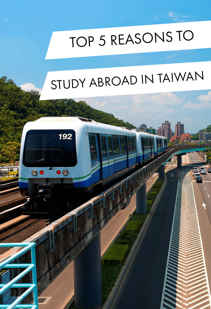 View of a train traveling on elevated rails of Taipei Metro System in suburban area under blue clear sky ~ View of railways in Mucha, Taipei, the capital city of Taiwan, on a beautiful sunny day