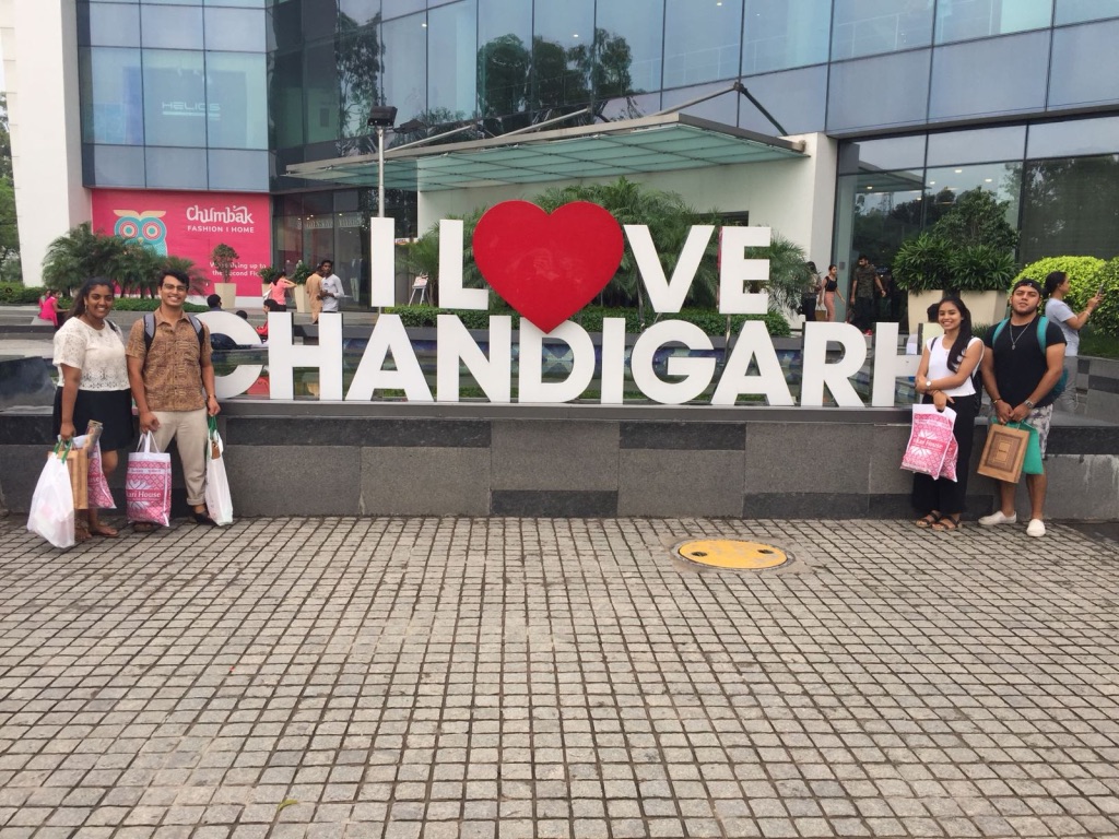 Four students near the 'I love Chandigarh' sign in India