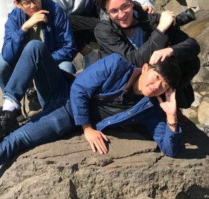 Four friends posing near a waterfall in Korea.
