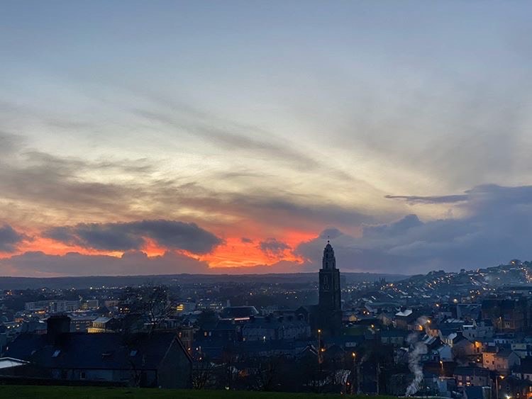 A fiery sunset over the Shandon Bells Tower in Cork, Ireland