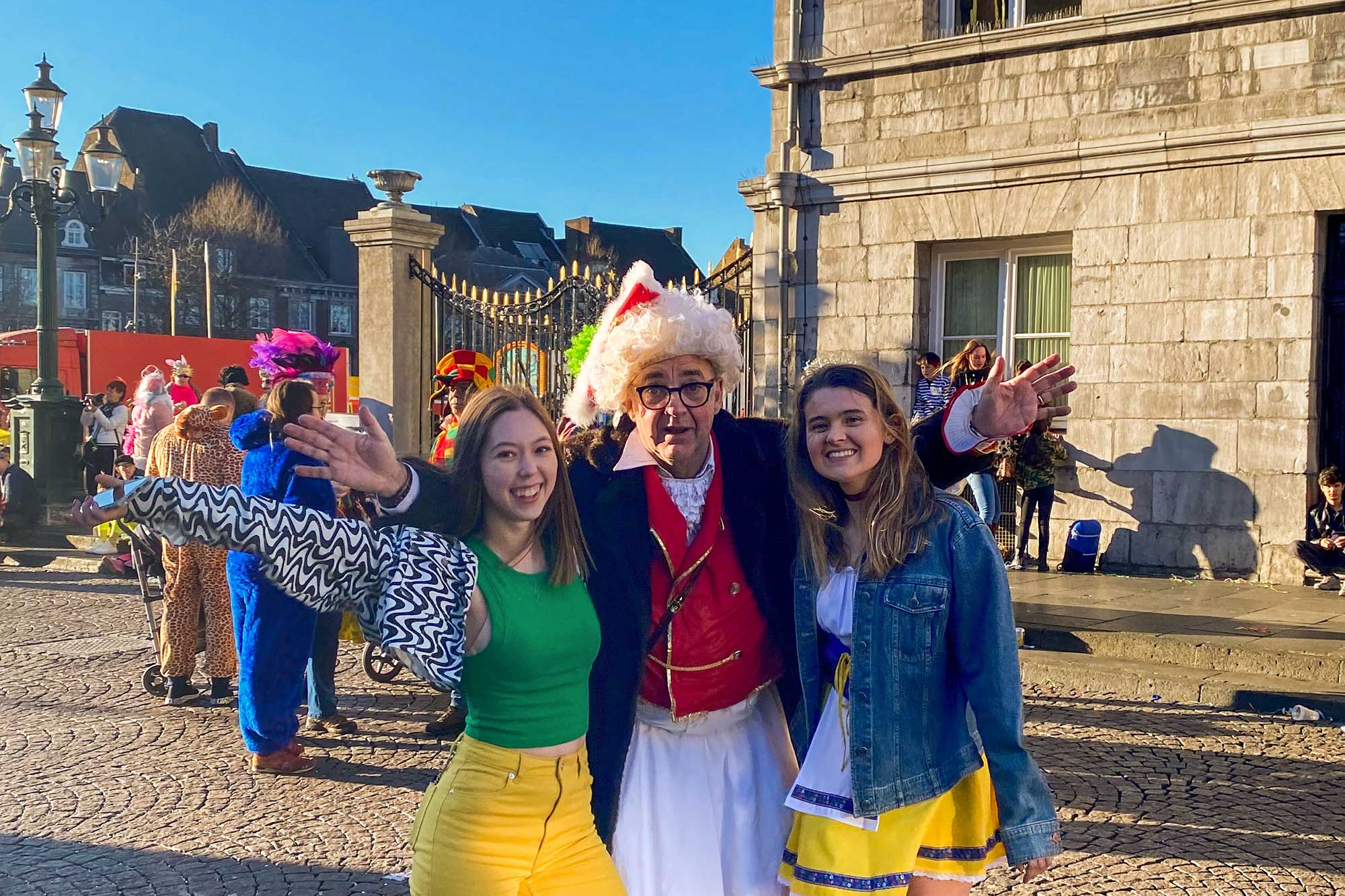 Students and carnival attendees in colorful attire at the Carnival 2022 in Maastricht.