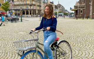 Student takes a bike ride in cobbled street area of Maastricht, the Netherlands.