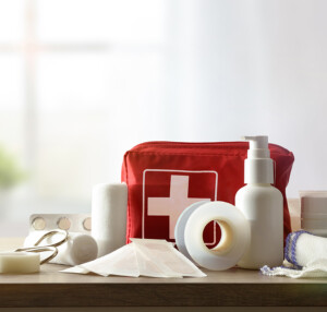 Basic home first aid kit laid out on a table