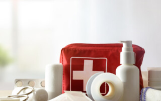 Basic home first aid kit laid out on a table