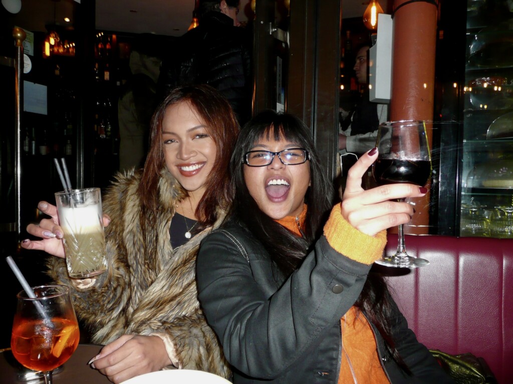 Two college students enjoying time together with wine and soda.