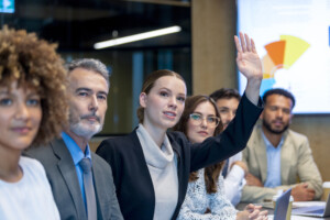 Businesswoman raising her hand. 