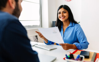 Friendly interview between HR female director and caucasian job candidate.