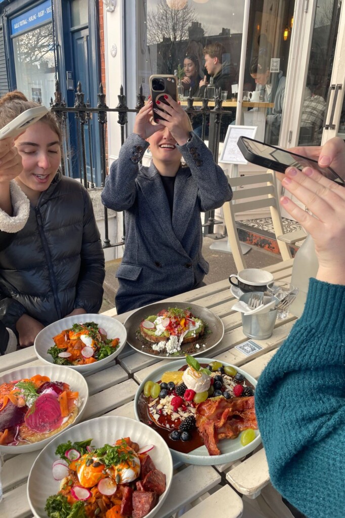 Students taking pictures of meals in Europe