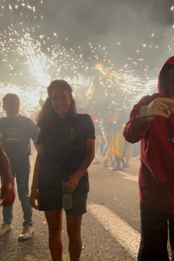 Students surrounded by fireworks on the street