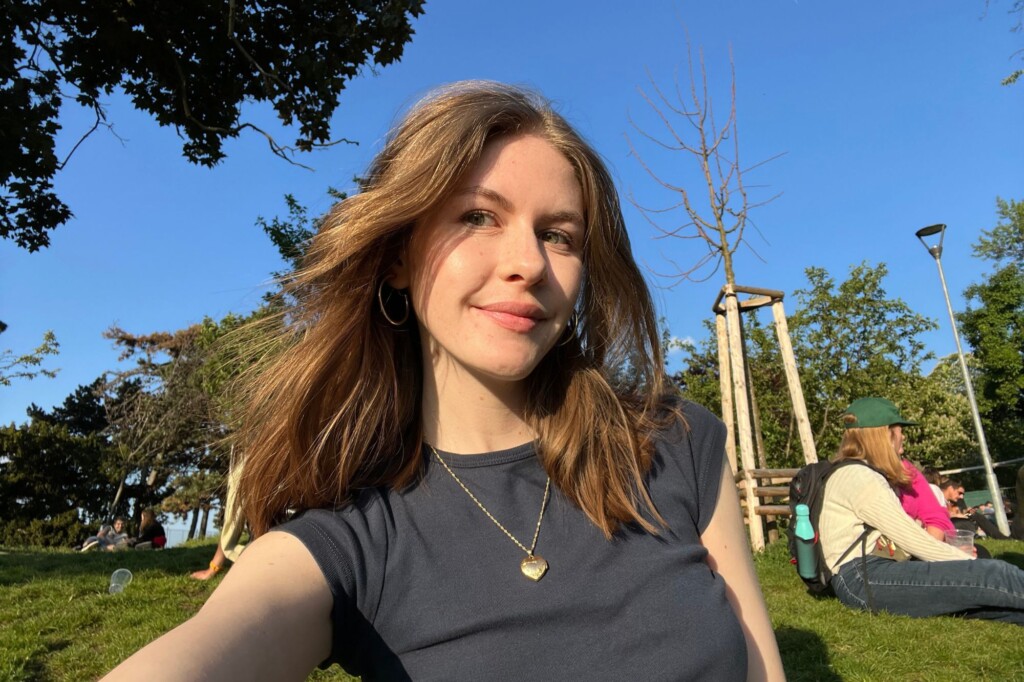 Kylee Cochran (UCI) traveling through Europe pictured in a green park