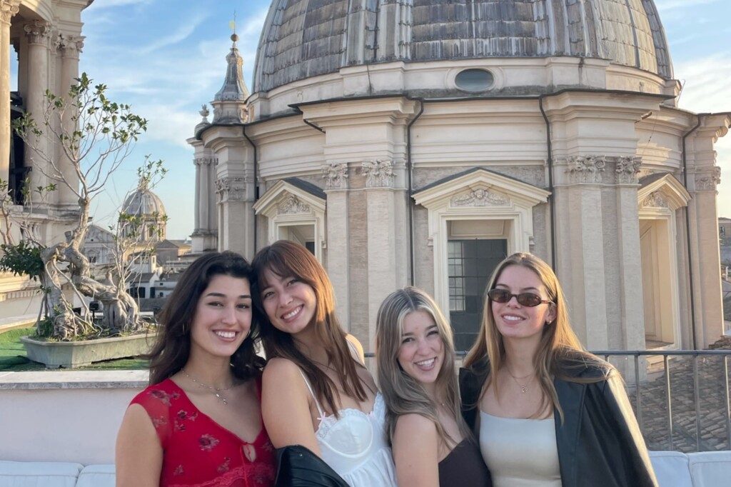 Students posing in front of a Roman copola
