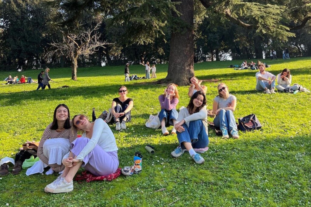 Students on beautiful green lawn in the sun