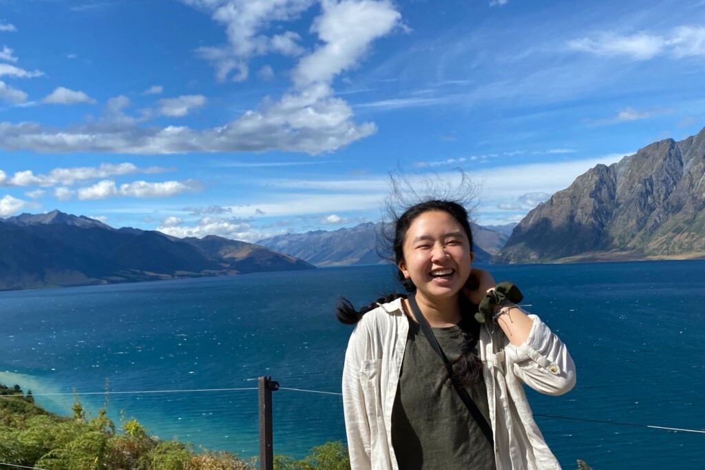 Leanna Chin (UCSD) in New Zealand with bay behind her