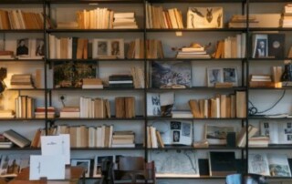 Academic room lined with full bookshelves and working tables