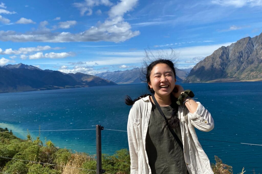Leanna Chin with a New Zealand bay behind her