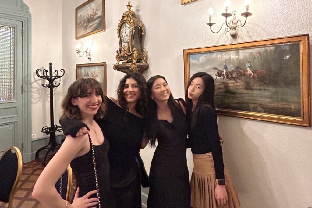 Micah-Rose and friends in France standing in front of art