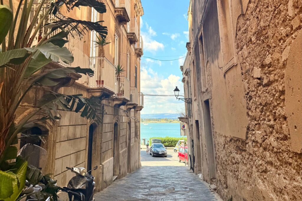 Cobblestone streets leading to the sea in Sicily