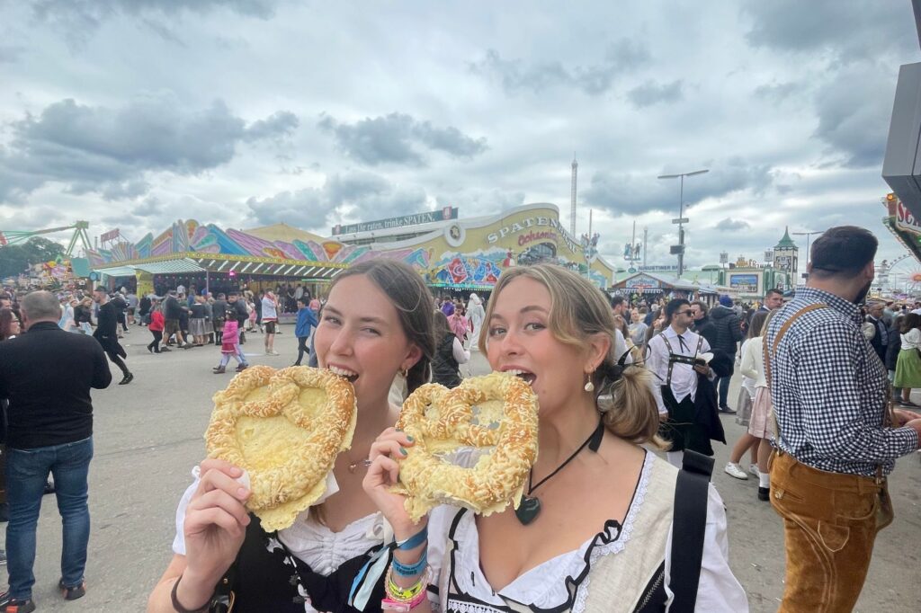Claire Scott (UCSB) at Oktoberfest in Munich with a friend eating pretzels
