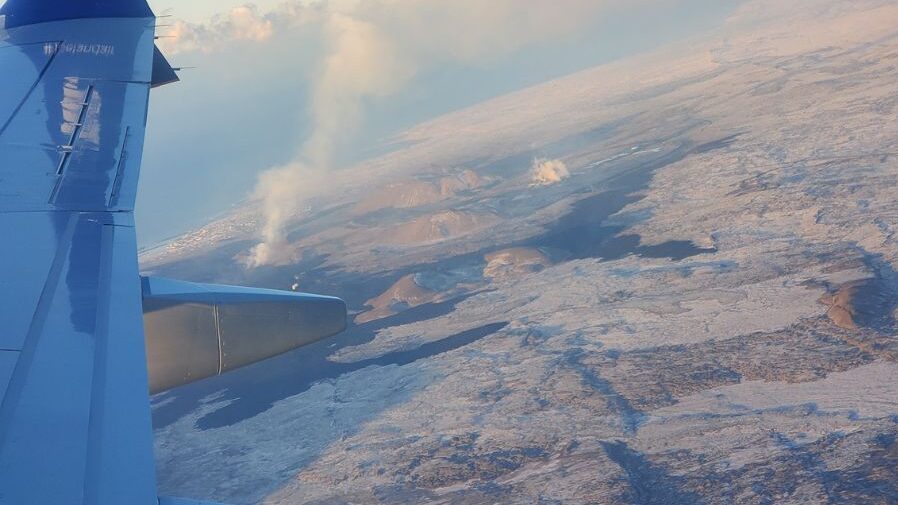 Picture out plane window high above clouds