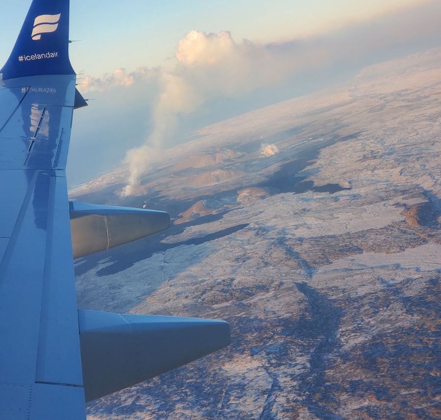 Picture out plane window high above clouds
