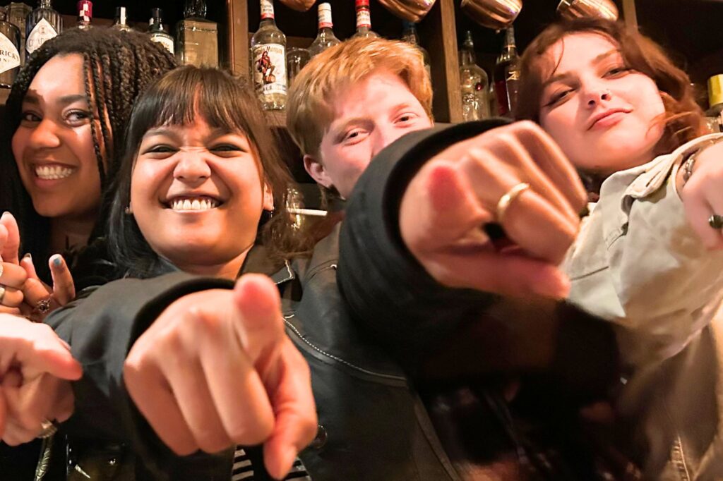 London Perelli (UCB) with friends at a pub pointing