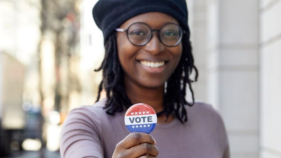 vote-from-abroad-featured Student with a I voted sticker